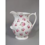 A large 19th century ewer, possibly Coalport, with painted pink rose decoration and supporting