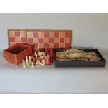 A box containing a collection of gaming pieces to include a part ivory chess sets and a part Mahjong
