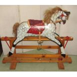 A traditional Edwardian style carved wooden rocking horse with dappled grey painted finish, horse