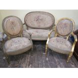 A 19th century three piece salon suite comprising a two seat sofa with oval cameo shaped back and