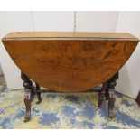A Victorian walnut dropleaf Sutherland tea table raised on turned and scrolled supports supports