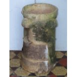 An unusual reclaimed buff coloured chimney pot of cylindrical form with applied moulded repeating
