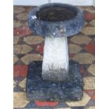 A small weathered three sectional rough hewn stone bird bath of circular form, with tapered