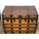 A vintage wooden timber lathe and steel banded steamer trunk, with leather strap carrying handles