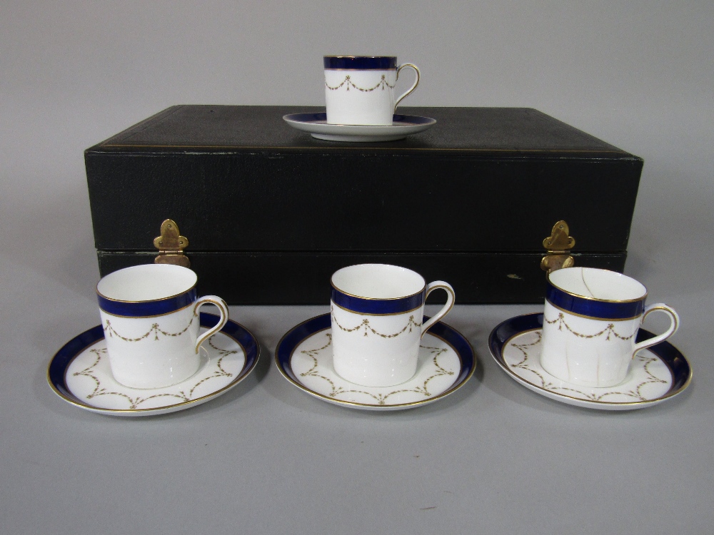 A cased set of six Aynsley coffee cans and saucers with blue and gilt decoration and with printed - Image 2 of 3