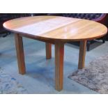 A contemporary light oak D end pull out extending dining table, with single additional bi-fold leaf,