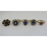 Five 9ct cluster dress rings comprising a sapphire and white stone example, sapphire and opal