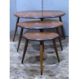 A Ercol medium elm nest of graduated 'pebble' occasional tables, raised on simple turned, tapered