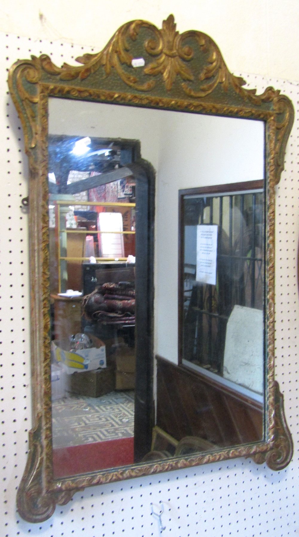 A Georgian style wall mirror, the rectangular plate set within a shaped and moulded frame, with gilt