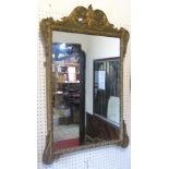 A Georgian style wall mirror, the rectangular plate set within a shaped and moulded frame, with gilt