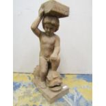 A carved hardwood figure of a young boy sitting astride a dolphin 46 cm high