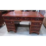 A reproduction Georgian style yew wood veneered twin pedestal writing desk with inset writing
