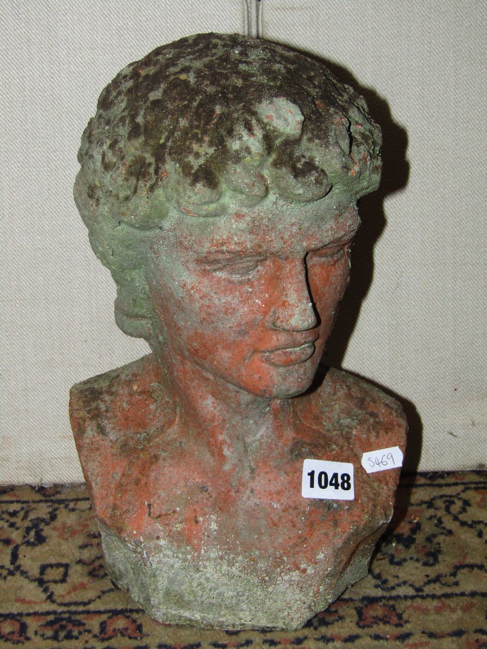 A small weathered terracotta head and shoulder bust in the form of a classical male character,