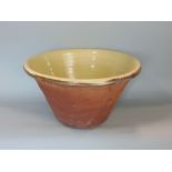 A good quality slipware glazed terracotta dairy bowl, 43cm diameter