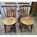 A set of four Ibex stick back kitchen chairs with circular moulded seats raised on splayed turned