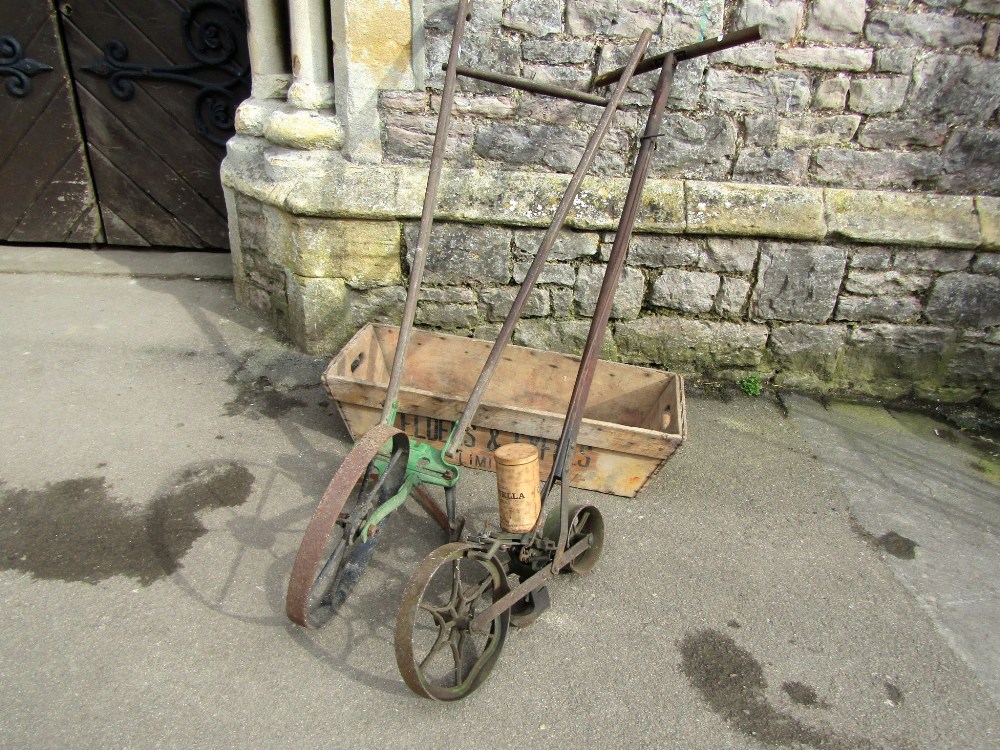 A vintage Planet Junior push hoe, with ashwood handle, together with a seed drill with two spoke