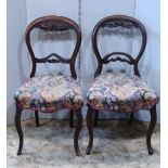 Two similar Victorian balloon back dining chairs with moulded frames, upholstered seats, cabriole