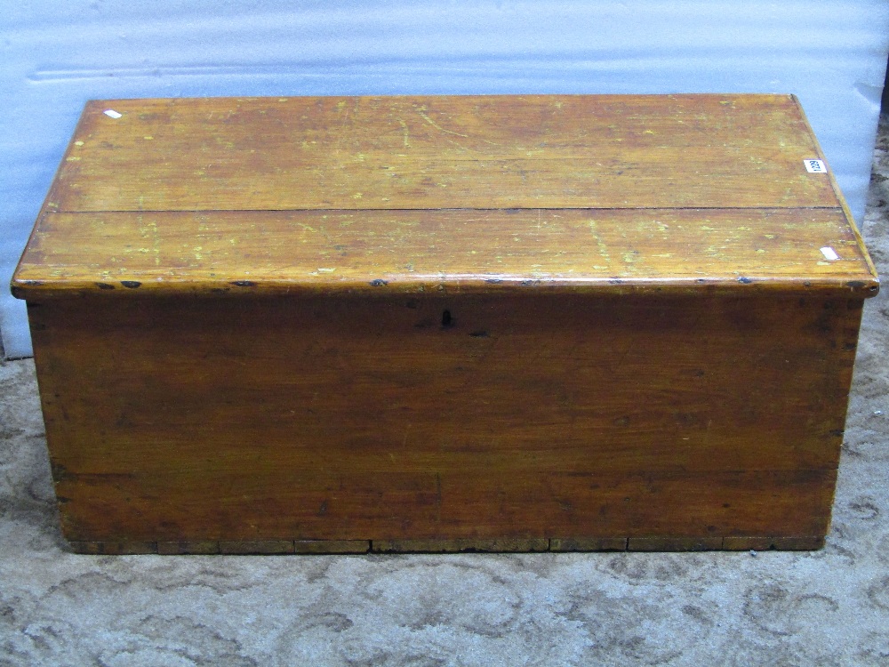 A 19th century pine blanket box with hinged lid, exposed dovetail construction and side carrying