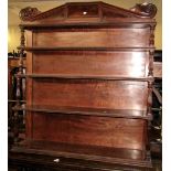 A Regency mahogany four tier waterfall wall mounted bookcase with vase shaped fluted column supports