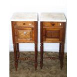 A matched pair of 19th century continental oak pot cupboards of square cut form with white and