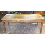 An early 19th century fruitwood dining table the heavy plank top raised on four square taper