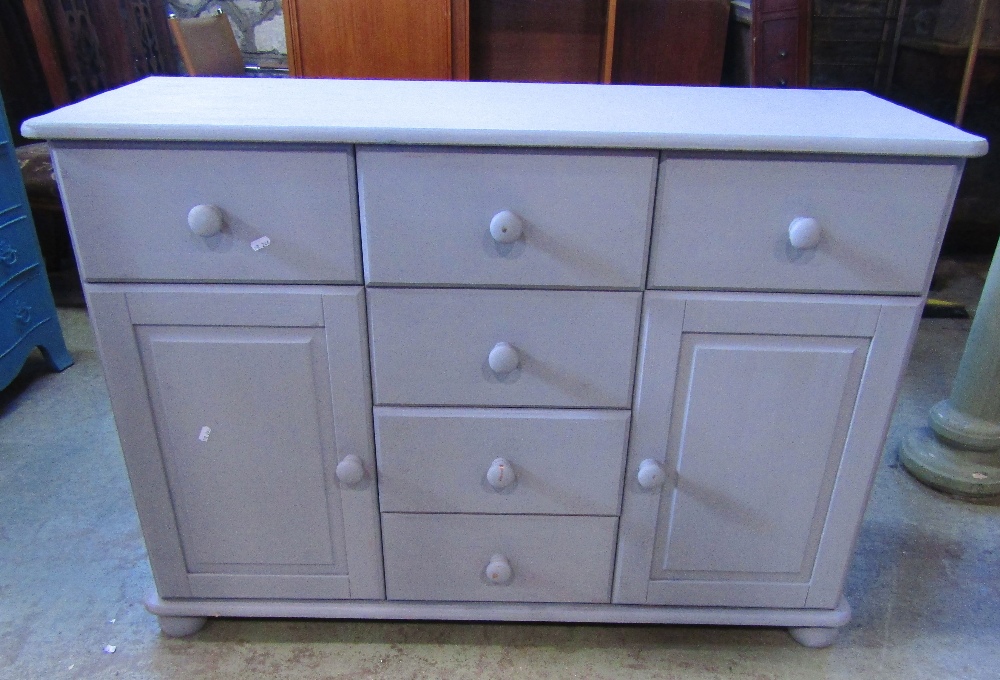 A contemporary pine dresser base, with painted finish, fitted with a T shaped arrangement of six