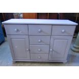 A contemporary pine dresser base, with painted finish, fitted with a T shaped arrangement of six