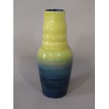 An unusual Moorcroft vase of shaped cylindrical form with graduated blue and yellow glaze and with
