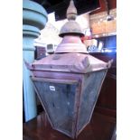 A lantern hood of square tapered form with glazed panels beneath a canopy and raised finial, the