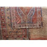 Three antique Persian rugs to include a Bokhara, 200 x 110cm, a Quashqai, 110 x 90cm and a further