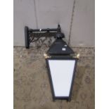 A Victorian style exterior wall mounted lantern of square tapered form with milk glass panels