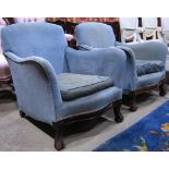 A pair of Georgian style low easy chairs with swept arms, serpentine seat, light blue ground