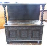 An old English oak buffet, the lower section enclosed by two doors with repeating carved floral