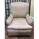 A substantial Edwardian library/drawing room chair with scrolled back and arms, later upholstered