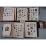 A collection of albums containing a quantity of armorial crests and badges, etc (7)