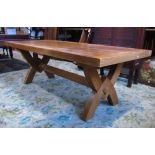 A good quality contemporary light oak dining table of rectangular form raised on X framed
