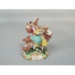 A 19th century Staffordshire figure group of the tailor's wife riding on a goat, after the Meissen