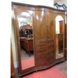 A substantial Edwardian mahogany triple wardrobe, the central section of bow-fronted outline, fitted