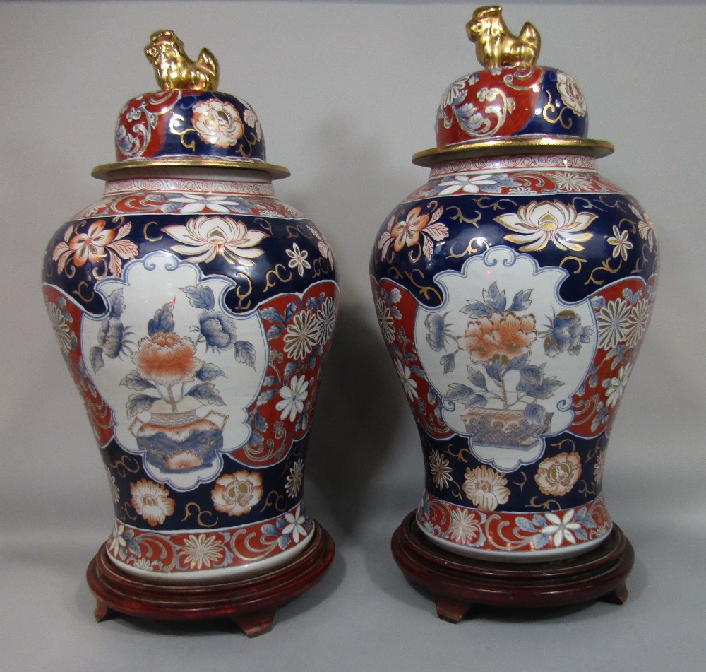 Large pair of Chinese Imari porcelain lidded baluster vases decorated with floral panels, the lids