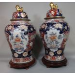 Large pair of Chinese Imari porcelain lidded baluster vases decorated with floral panels, the lids