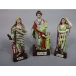A set of three early 19th century Staffordshire figures representing Faith, Hope and Charity, all