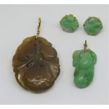 Group of carved hardstone (possibly jade) jewellery depicting fruit, comprising two pendants, each