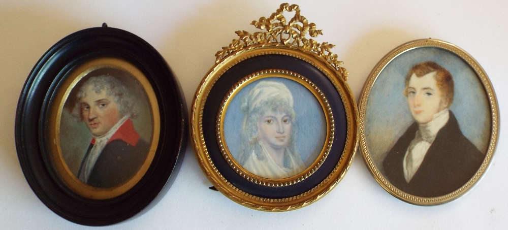 A late 18th century portrait miniature of oval form showing a gentleman in blue coat with red - Image 2 of 3