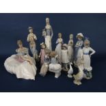 A collection of Nao and similar figures including a seated woman in voluminous skirt, 31 cm tall