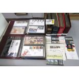 Seven albums containing a collection of Royal Mail FDCs, some with associated commemorative coins,