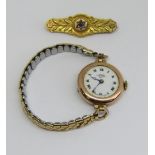 Early 20th century 9ct Buren watch with enamel dial and Roman numerals, associated plated concertina