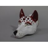 A 19th century stirrup cup in the form of a fox mask, 11 cm long approx
