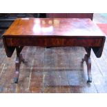 A 19th century mahogany sofa table with cross banded detail and flame veneers fitted with two frieze
