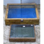 Two small oak and pine framed shallow portable display cases of rectangular form, with glazed