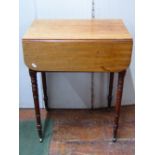 A small Georgian mahogany ladies sewing table fitted with two real and two dummy drawers on turned